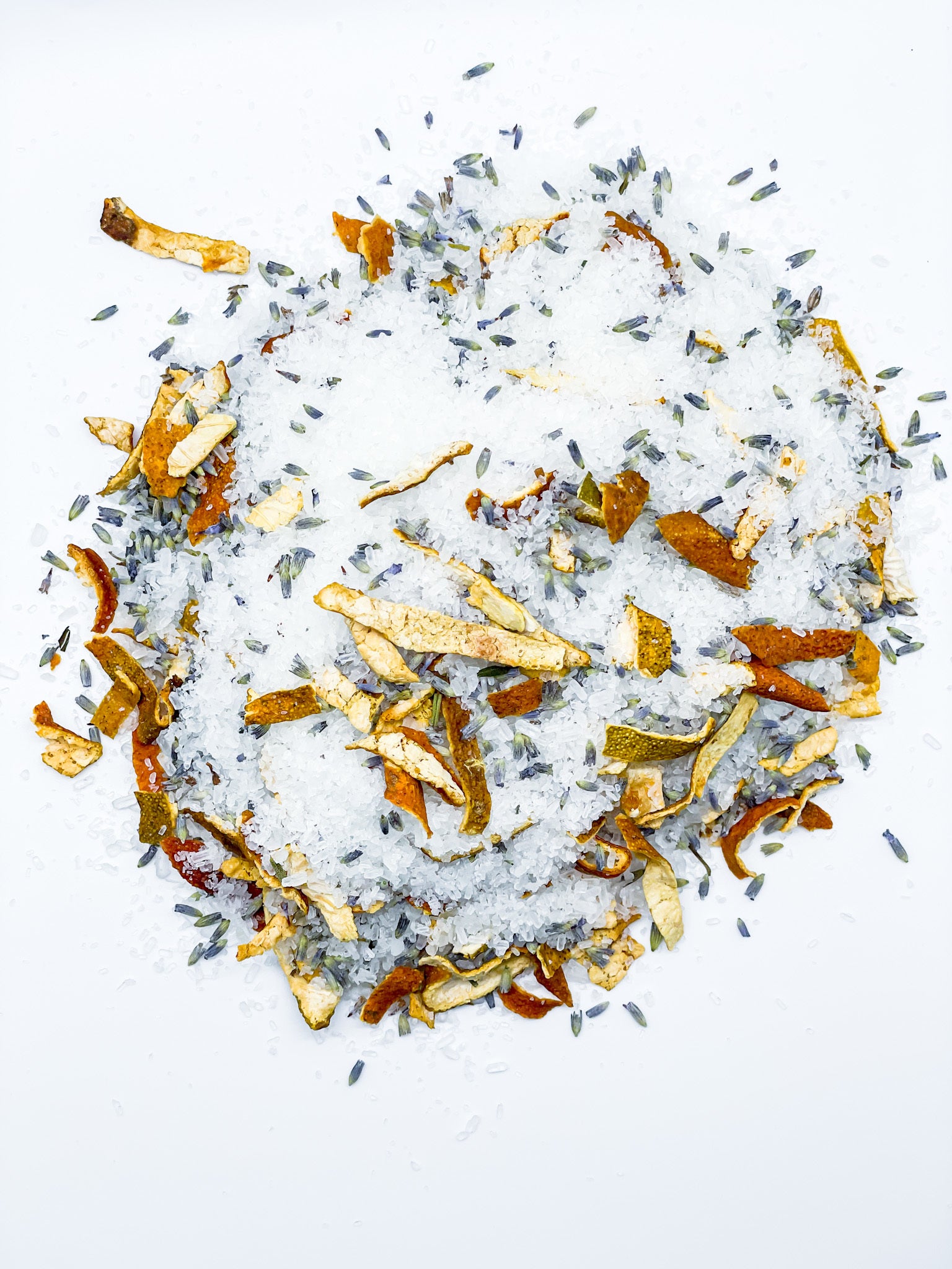 A resealable kraft pouch filled with Lavender + Sweet Orange Bath Salt, showcasing dried lavender buds and orange peels.