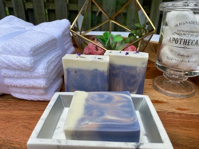 Lavender & Sweet Orange Cold Process Soap with swirls and dried lavender flowers on top, showcasing its creamy texture and vibrant colors.