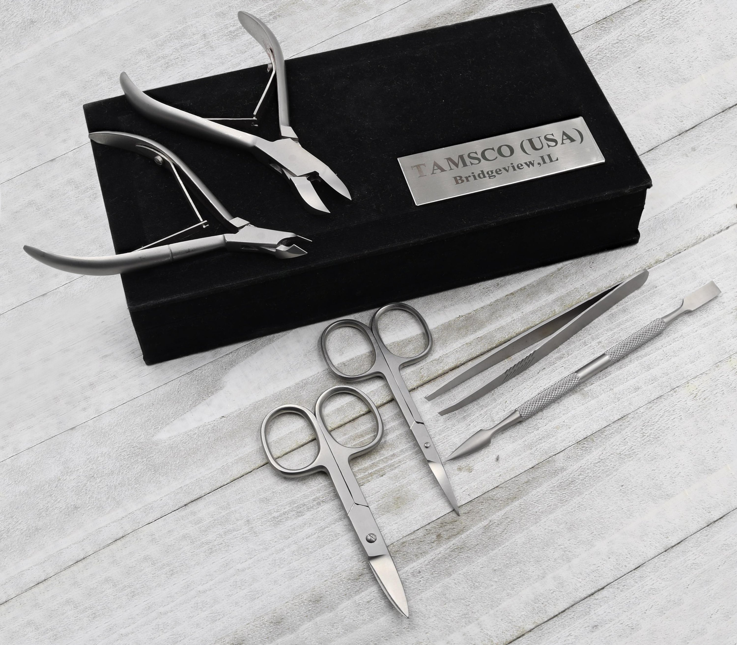 Professional Grade Manicure/Pedicure Kit with six stainless steel tools in a felt-lined gift box.