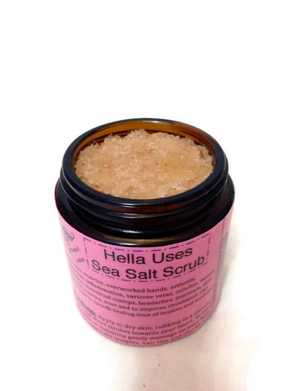 Organic Hella Uses Sea Salt Scrub in a glass jar with Himalayan Sea Salt and herbs, showcasing its natural ingredients and soothing properties.