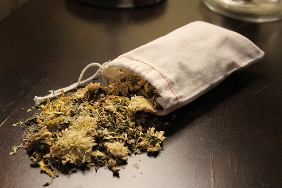 A soothing blend of organic herbs in a muslin bag for skin care bath tea, designed for irritated skin relief.