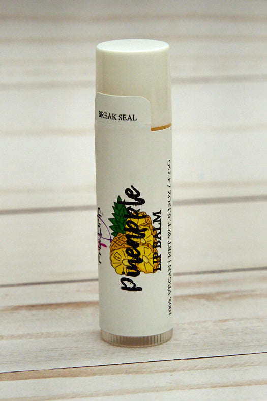 A vibrant tube of Pineapple Lip Balm with a tropical design, showcasing its fruity scent and natural ingredients.