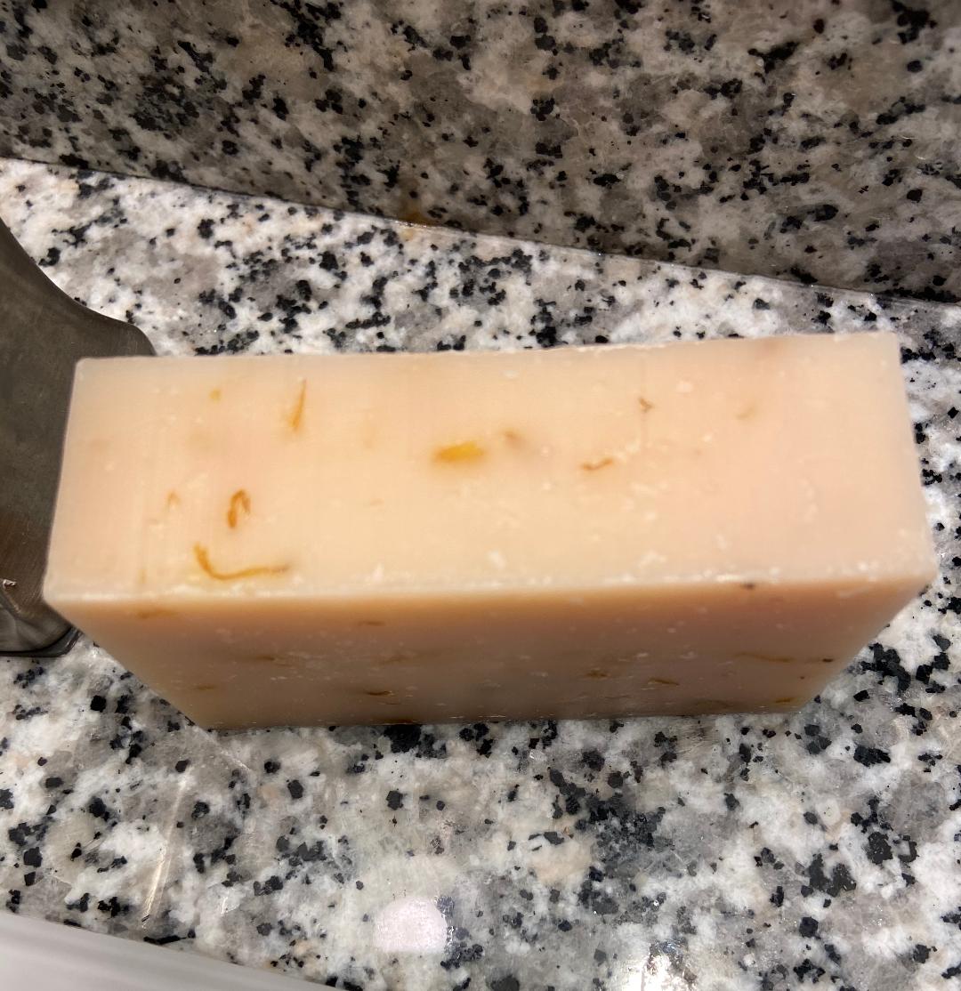 Prairie Sage Soap bar with calendula petals, sage, lemongrass, and spearmint essential oils, showcasing its organic and vegan qualities.