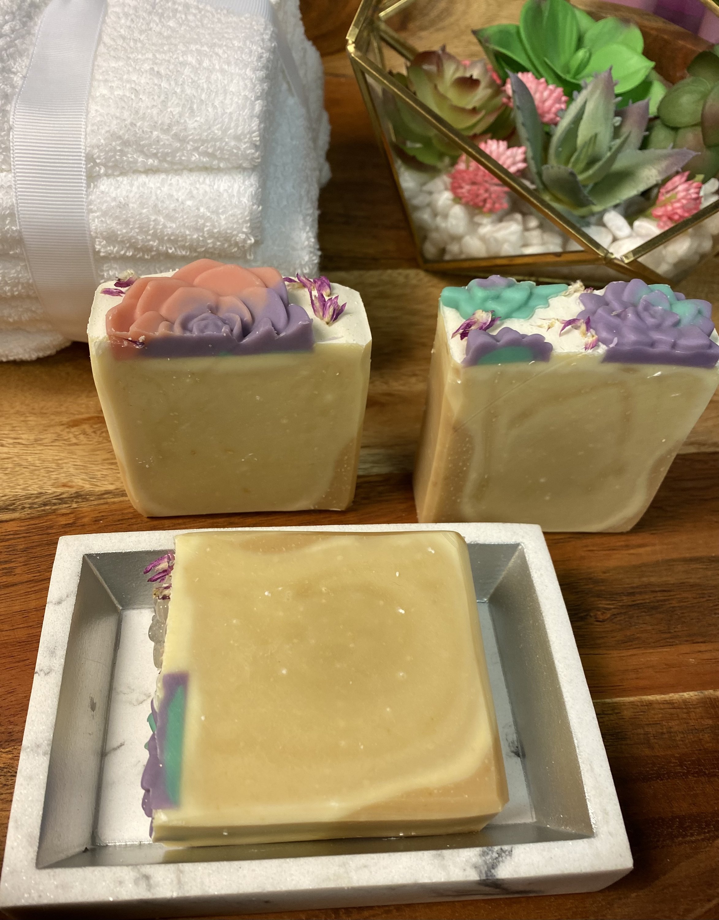 A bar of Soothing Goats Milk Peach Succulent Soap with a creamy texture and peach color, ideal for sensitive skin.