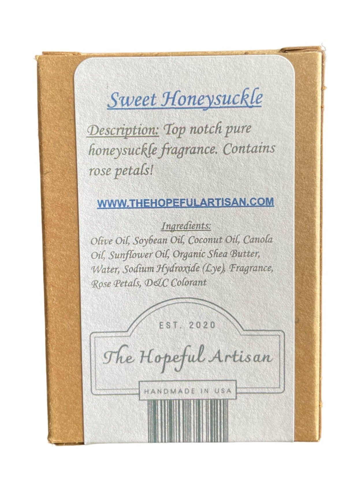 A bottle of Sweet Honeysuckle fragrance with rose petals, showcasing its elegant design and natural ingredients.
