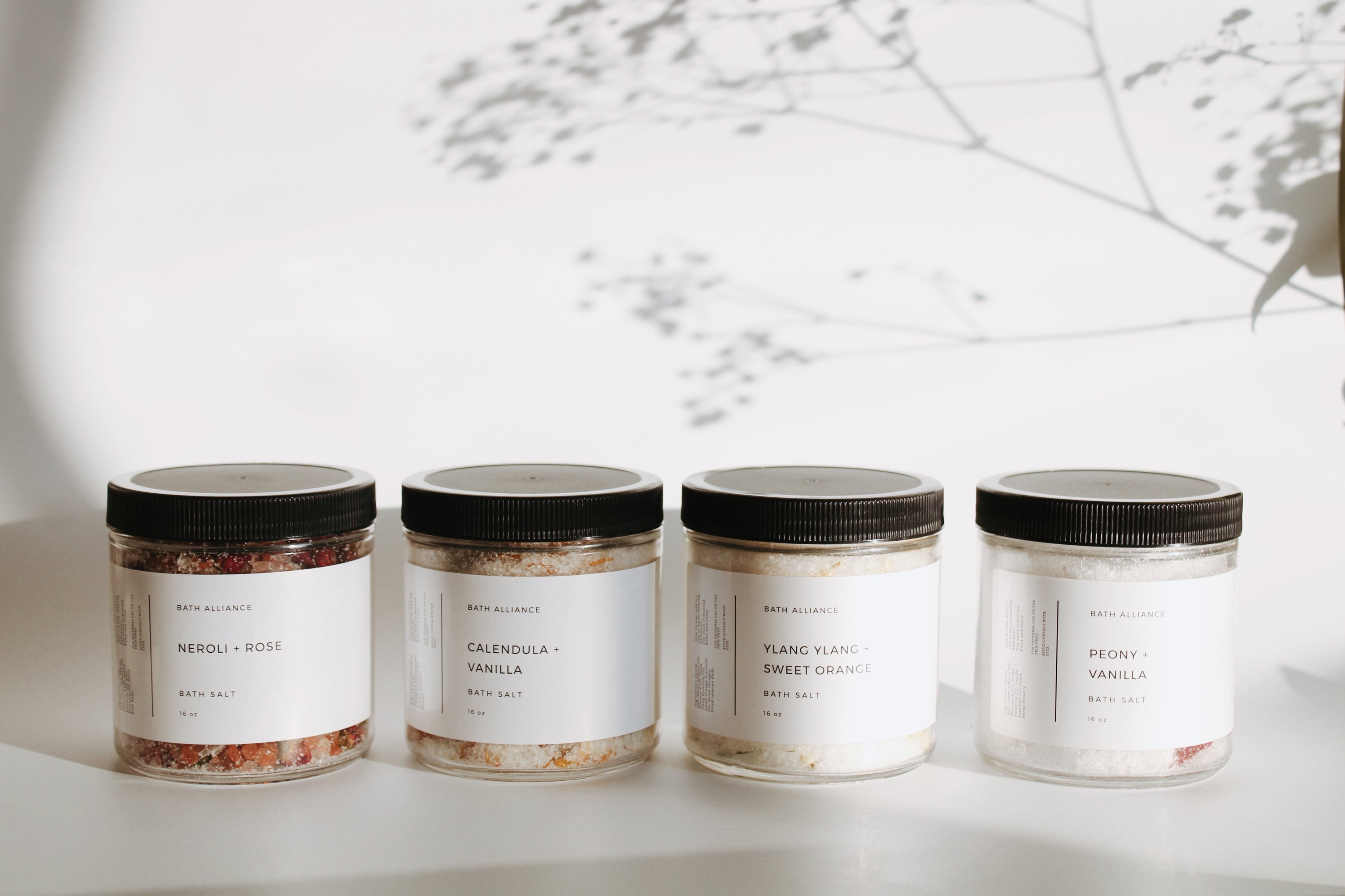 Sweet + Sensual Bath Salt Set featuring four jars of unique blends: Peony + Vanilla, Calendula + Vanilla, Neroli + Rose, and Ylang Ylang + Sweet Orange.
