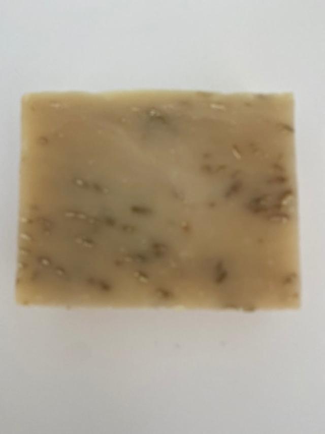 A bar of Unscented Oatmeal Soap with visible ground oats and a creamy texture, perfect for sensitive skin.