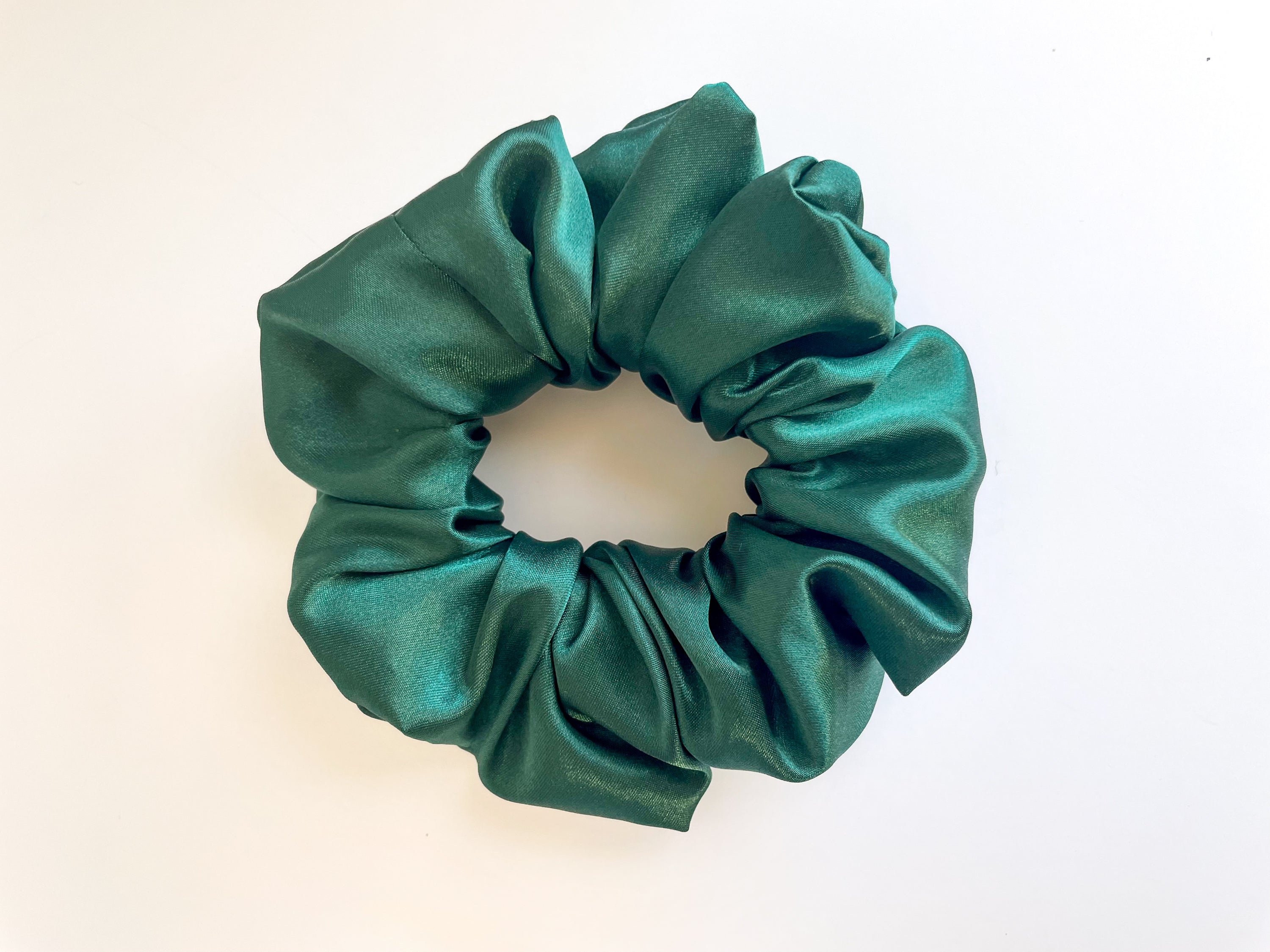 Alpine satin scrunchie in various colors, showcasing its smooth texture and elegant design.