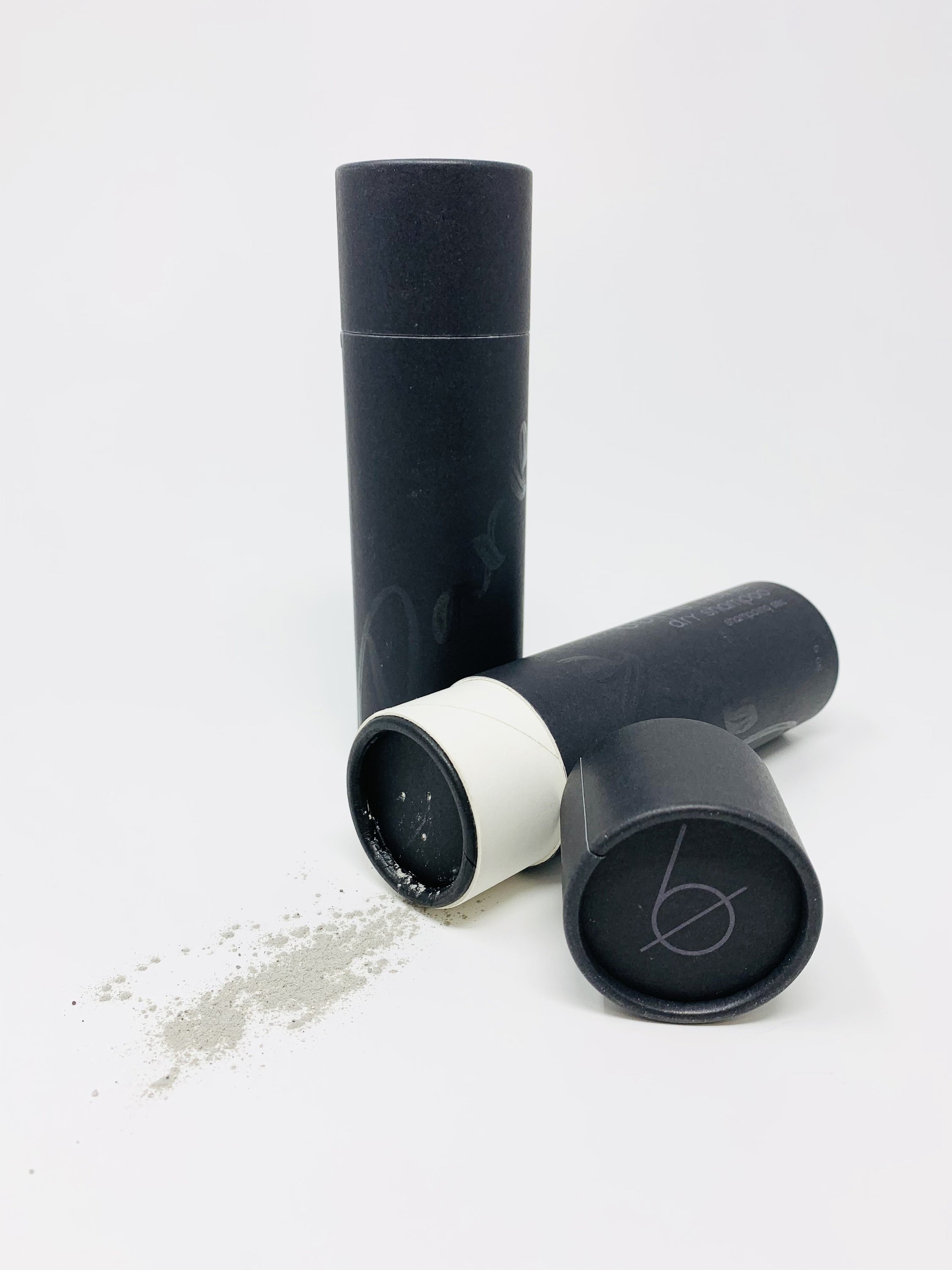 A 90g tube of Dry Shampoo-Dark designed for dark hair, featuring a sleek design and easy application method.