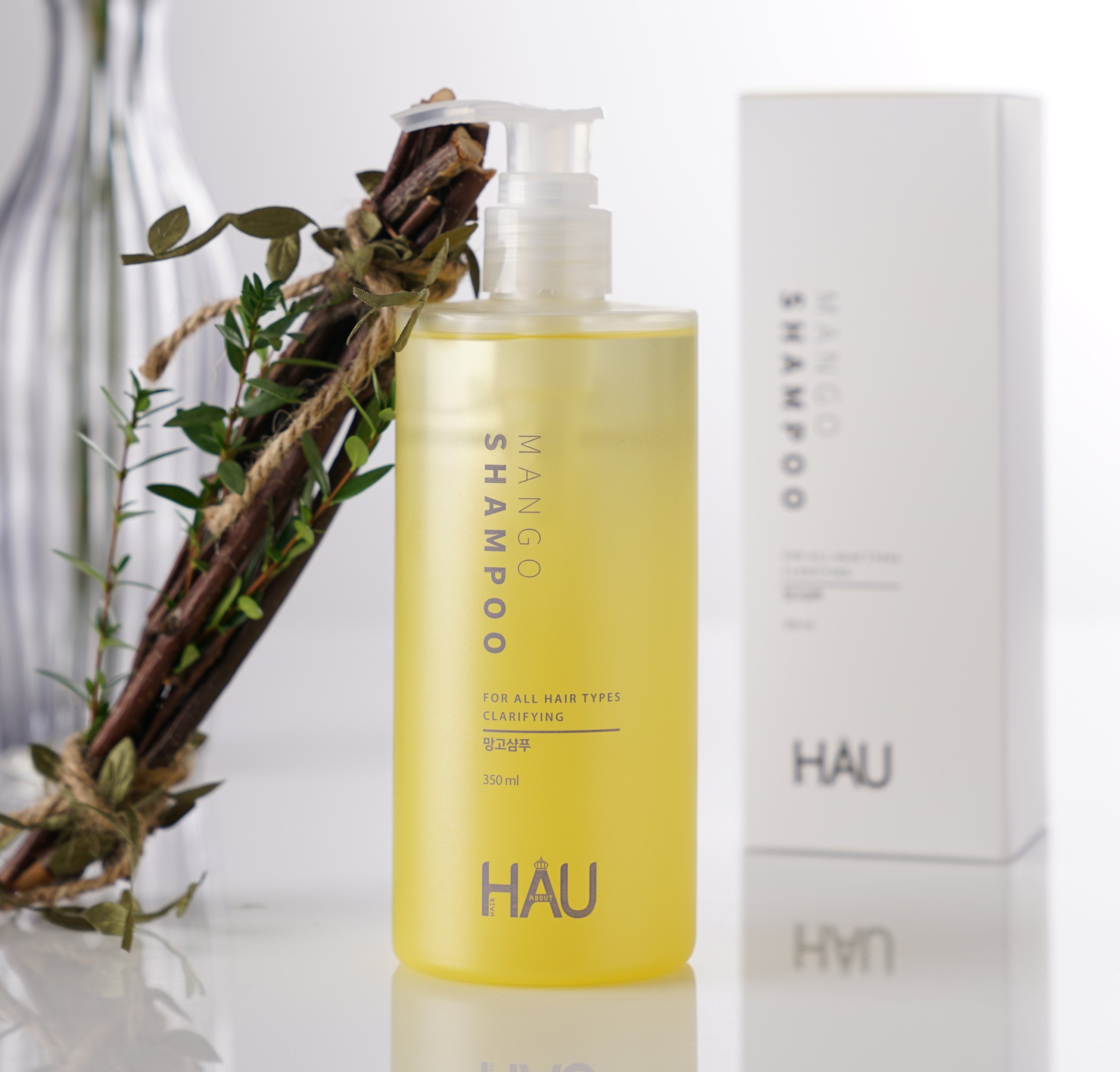 HAU Professional Mango Shampoo bottle with vibrant mango design, showcasing its natural ingredients for healthy hair.