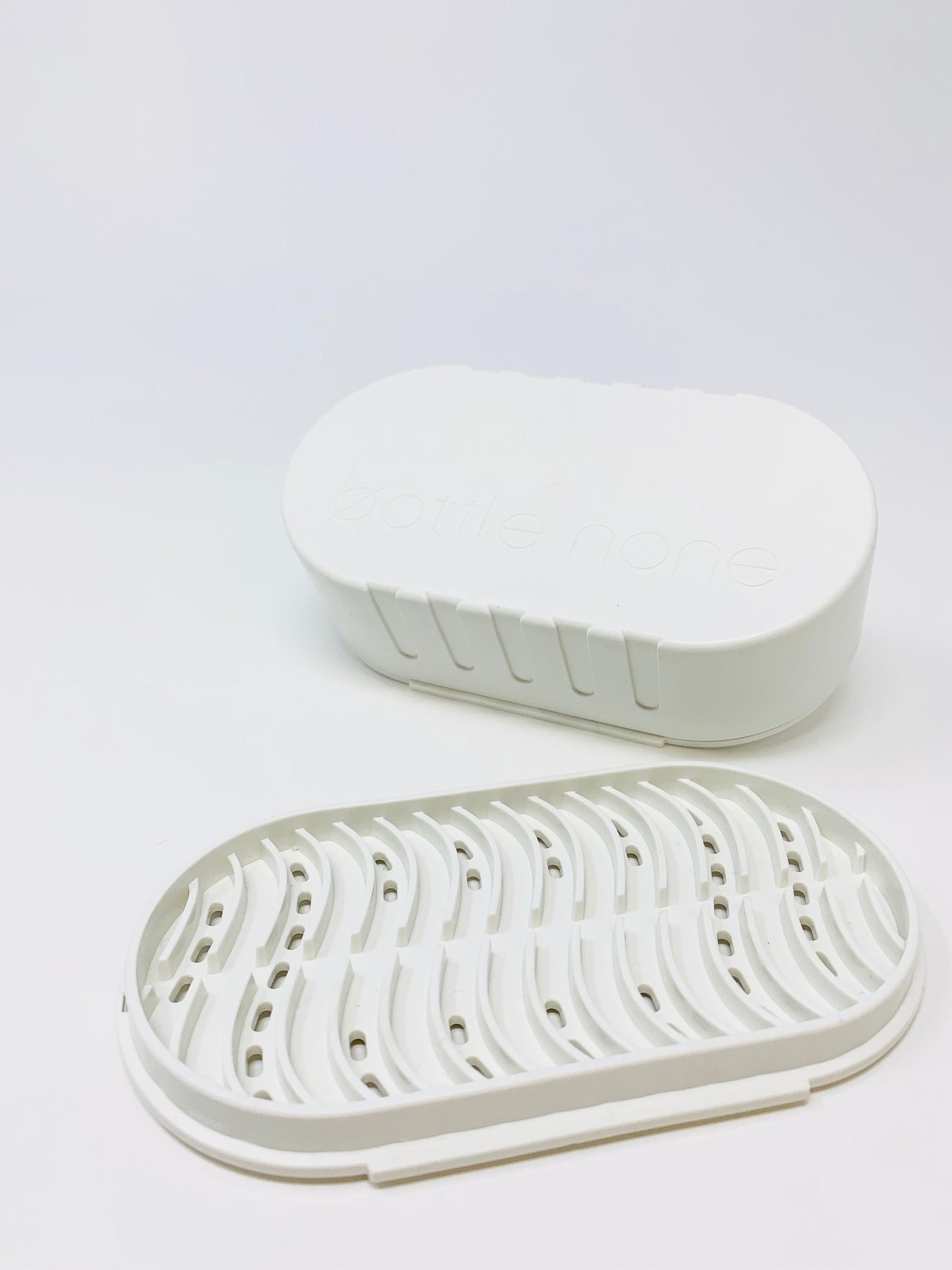 Eco-friendly travel case and soap dish made from recycled Canadian plastic, showcasing its compact design and sustainable materials.