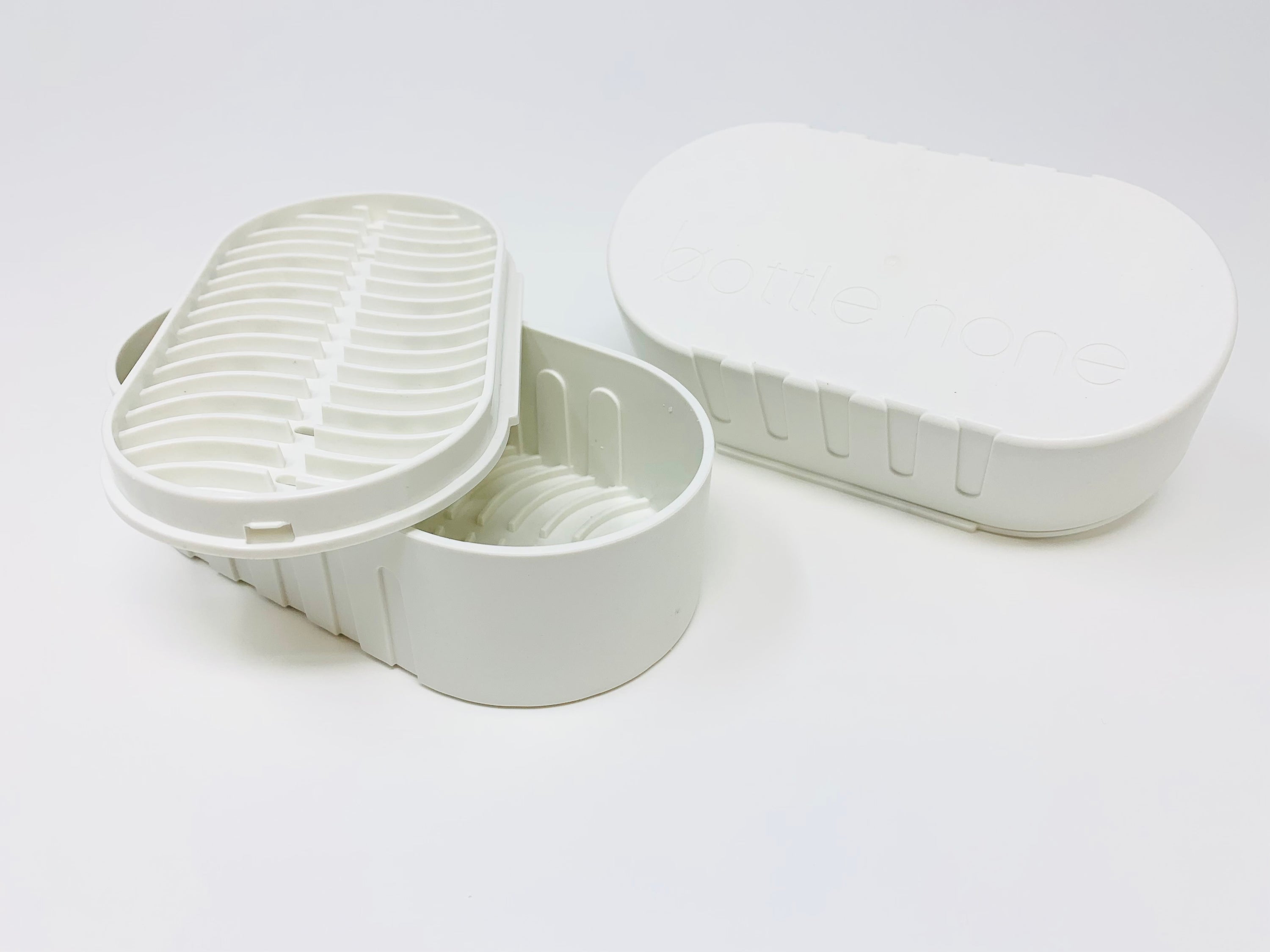 Eco-friendly travel case and soap dish made from recycled Canadian plastic, showcasing its compact design and sustainable materials.