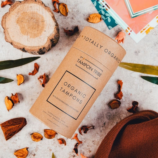 A tube of Super Plus Organic Tampons, 12ct, showcasing eco-friendly packaging and organic cotton tampons.