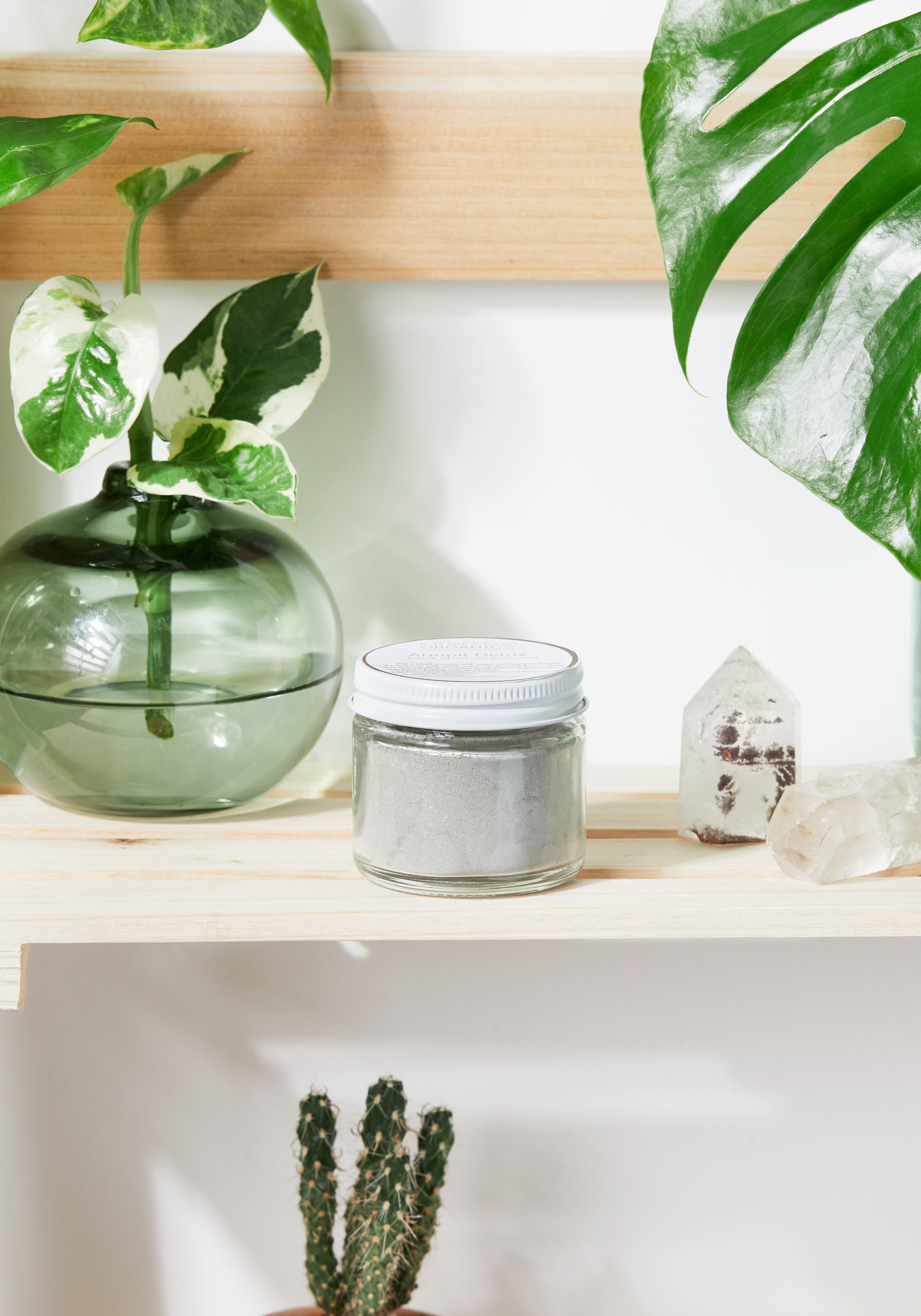A jar of Arm Pit Detox featuring natural ingredients like French Green Clay, Activated Charcoal, and Lavender, designed for detoxifying underarms.
