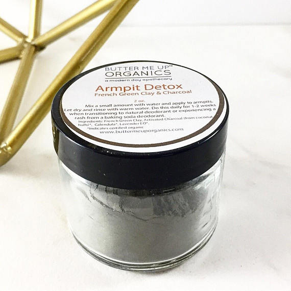 A jar of Arm Pit Detox featuring natural ingredients like French Green Clay, Activated Charcoal, and Lavender, designed for detoxifying underarms.