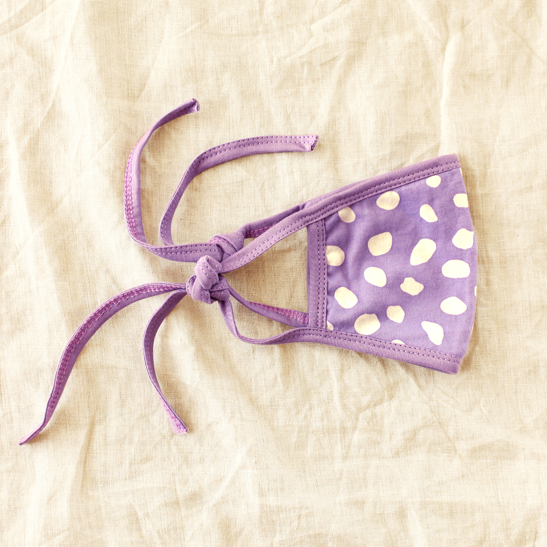 ARNOLDI 3-ply Organic Cotton Face Mask in Lilac, featuring a unique floral pattern and adjustable straps for a comfortable fit.