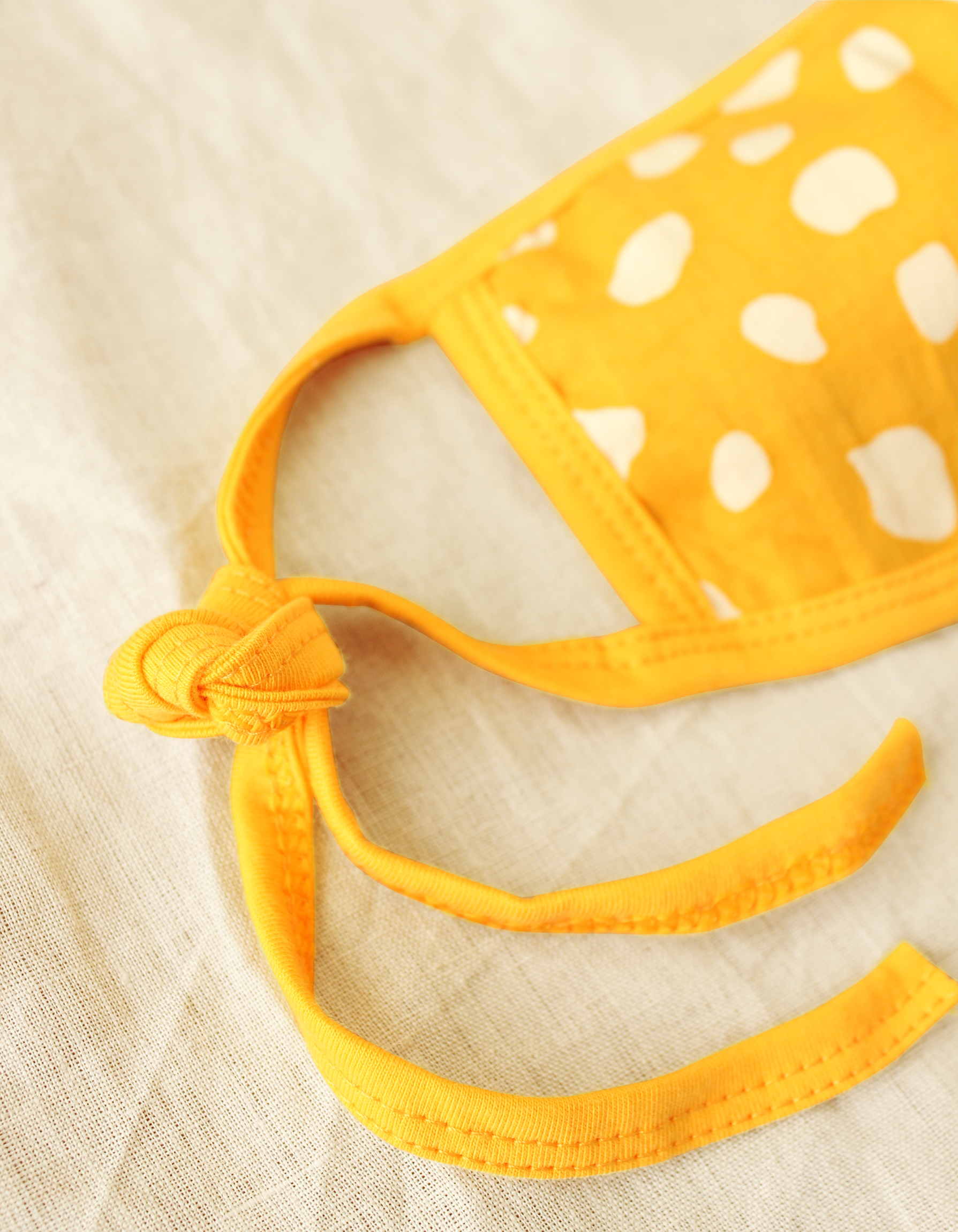 ARNOLDI 3ply Organic Cotton Face Mask in Golden Saffron, featuring a joyful design and waterproof filter, showcasing the unique Arnoldi pattern.