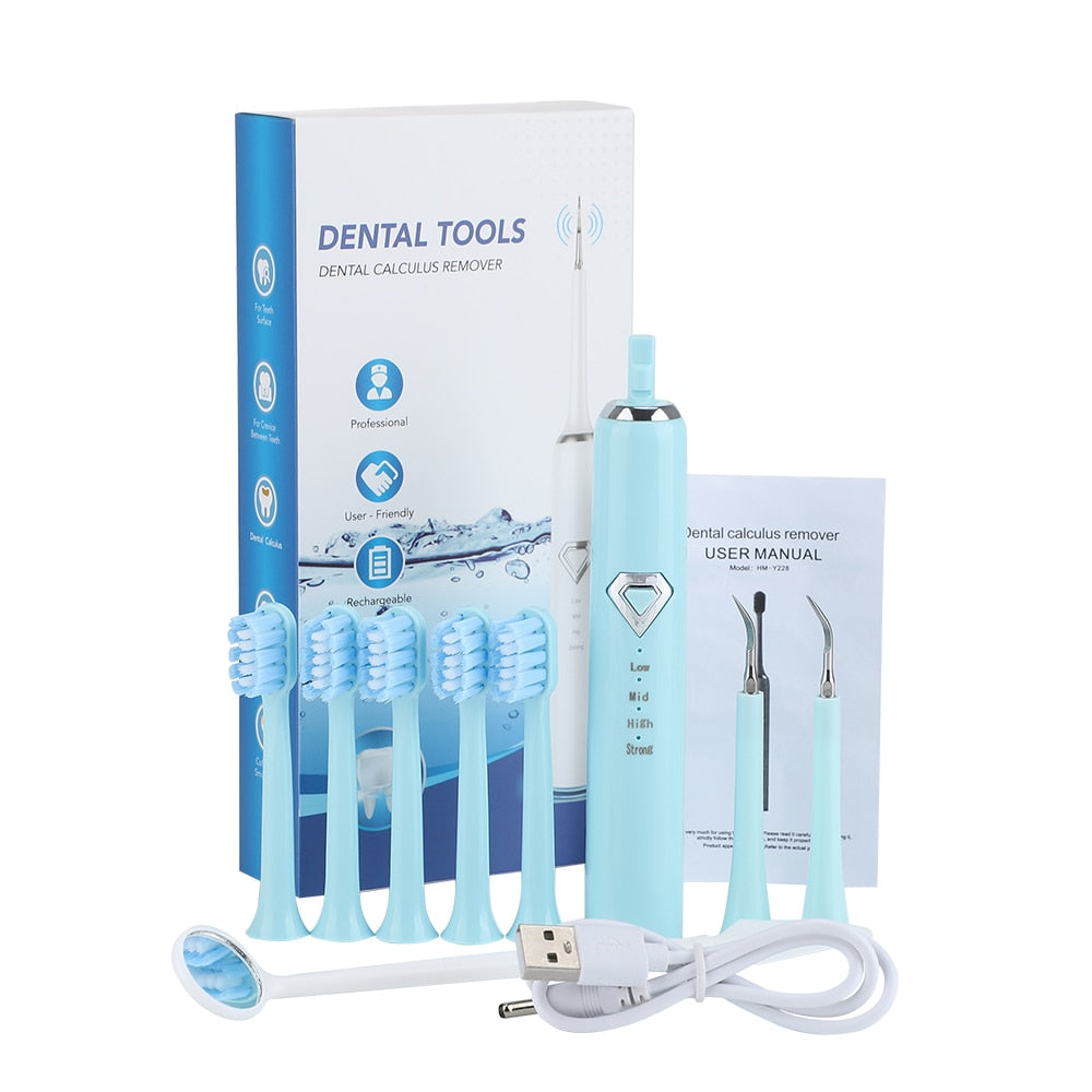 Dental Tartar Cleaner Electric Toothbrush with multiple cleaning heads and USB charging cable, designed for effective teeth whitening and tartar removal.
