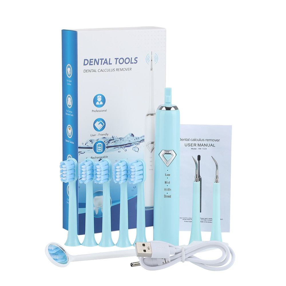 Dental Tartar Cleaner Electric Toothbrush with multiple cleaning heads and USB charging cable, designed for effective teeth whitening and tartar removal.