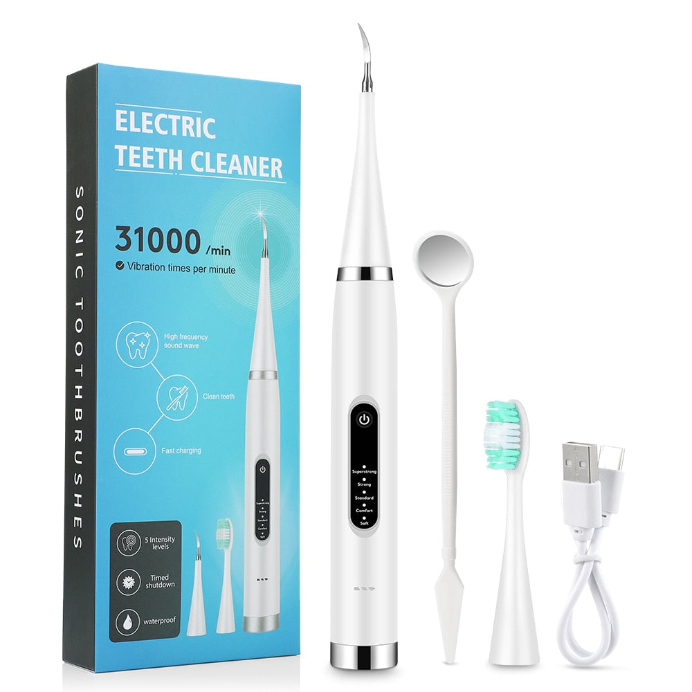 Electric Teeth Tartar Cleaner with multiple brush heads and USB charging cable, designed for effective dental care.
