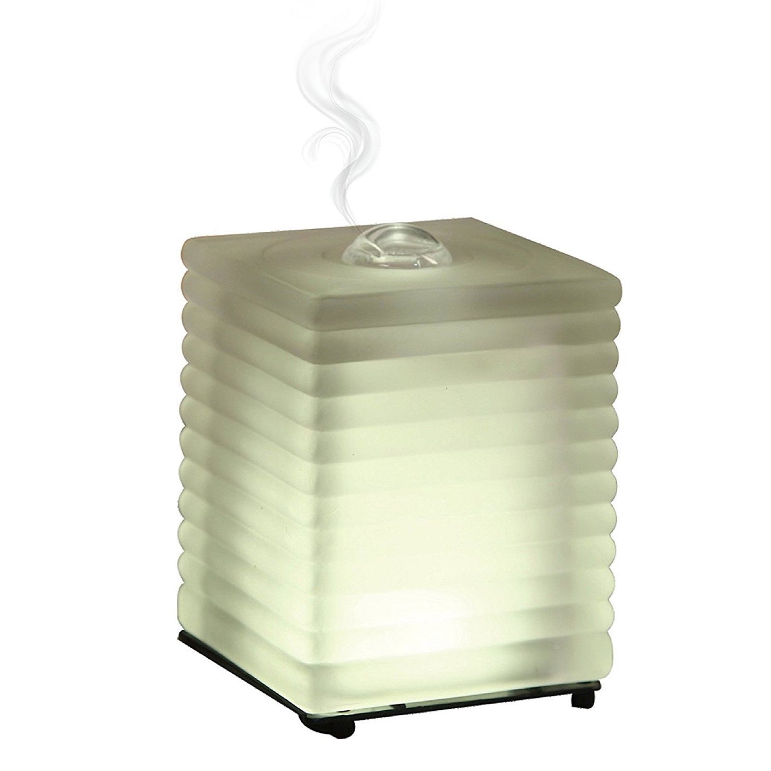 A stylish glass essential oil diffuser with a warm white LED light, designed for aromatherapy and home decor.