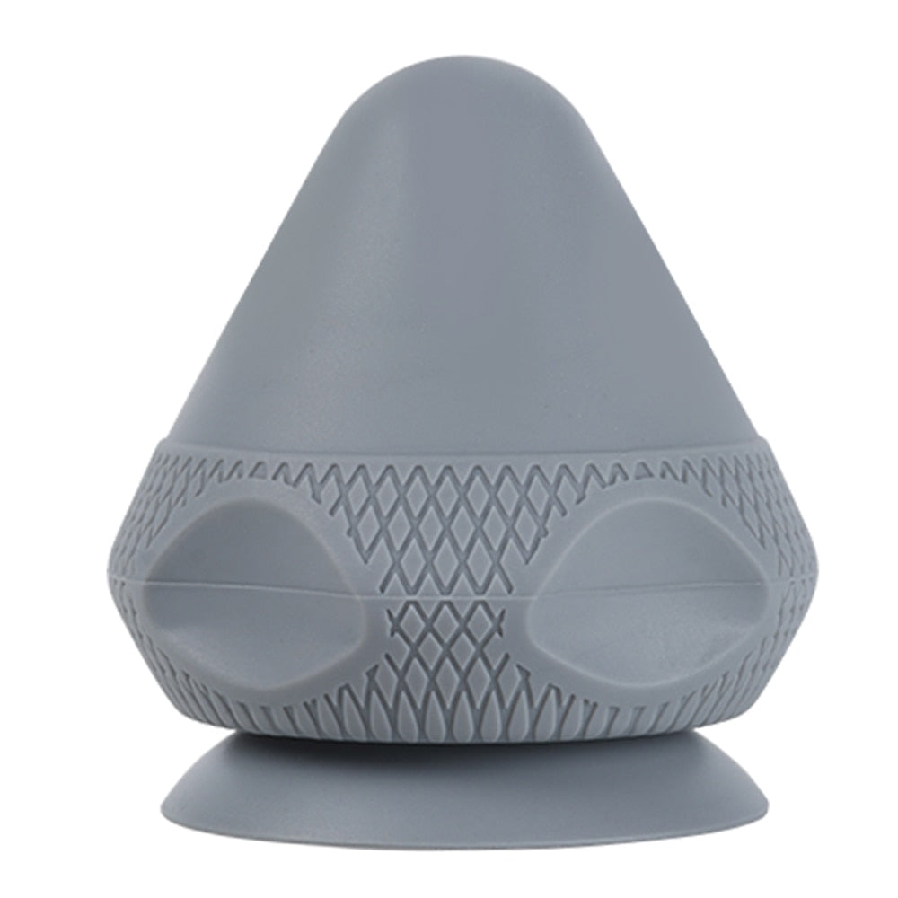 A silicone massage ball with a suction cup designed for deep tissue massage and muscle pain relief, showcasing its smooth surface and compact size.