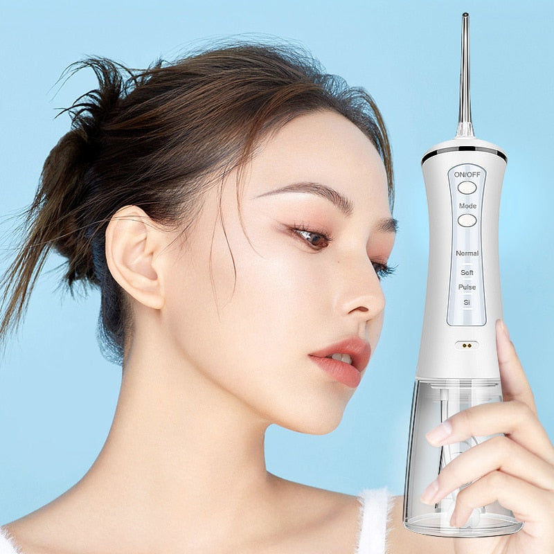 Newest Electric Oral Dental Irrigator Portable Water Jet Flosser with USB charging, showcasing its sleek design and included nozzles.