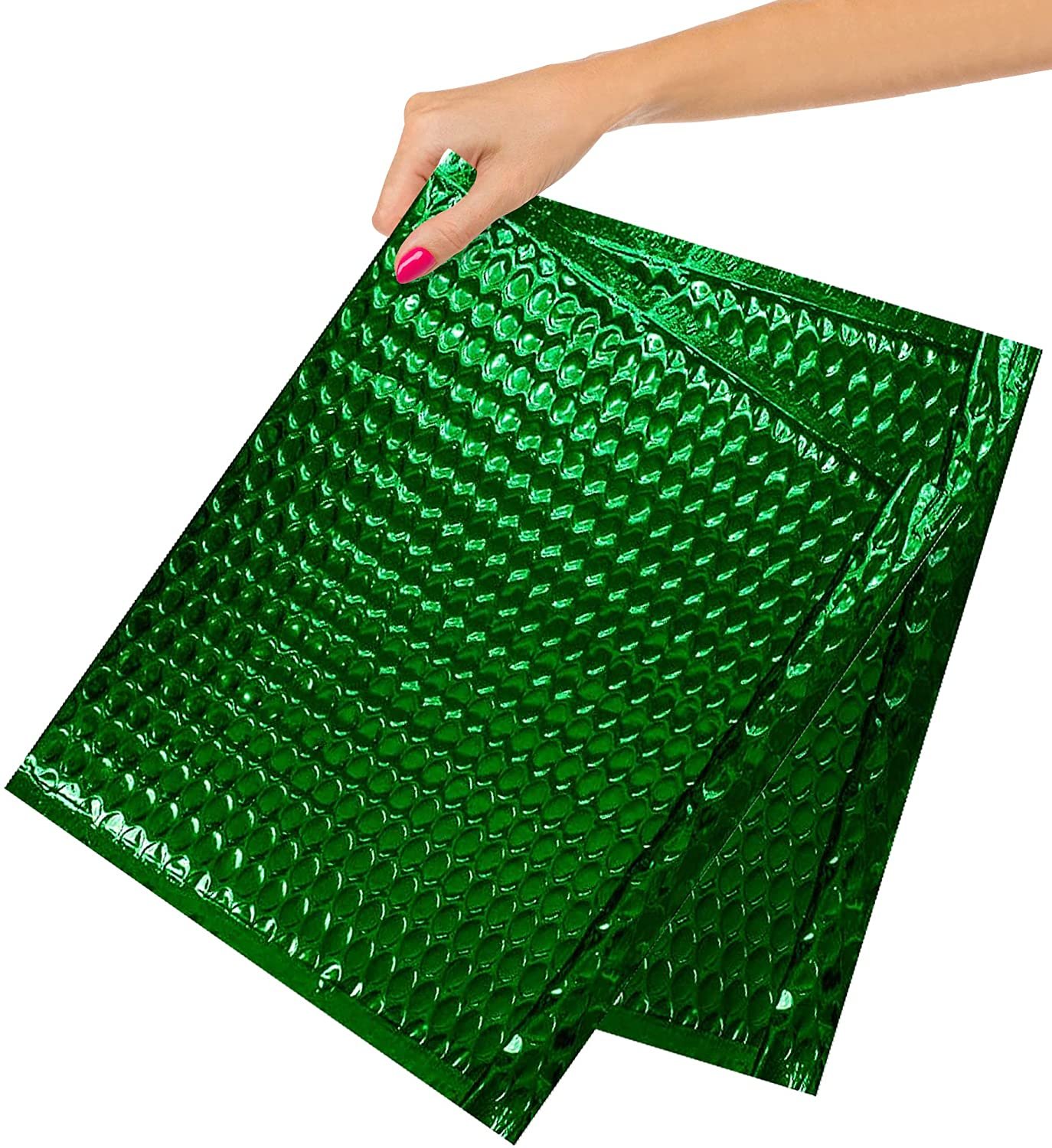 Hand holding green bubble mailers.