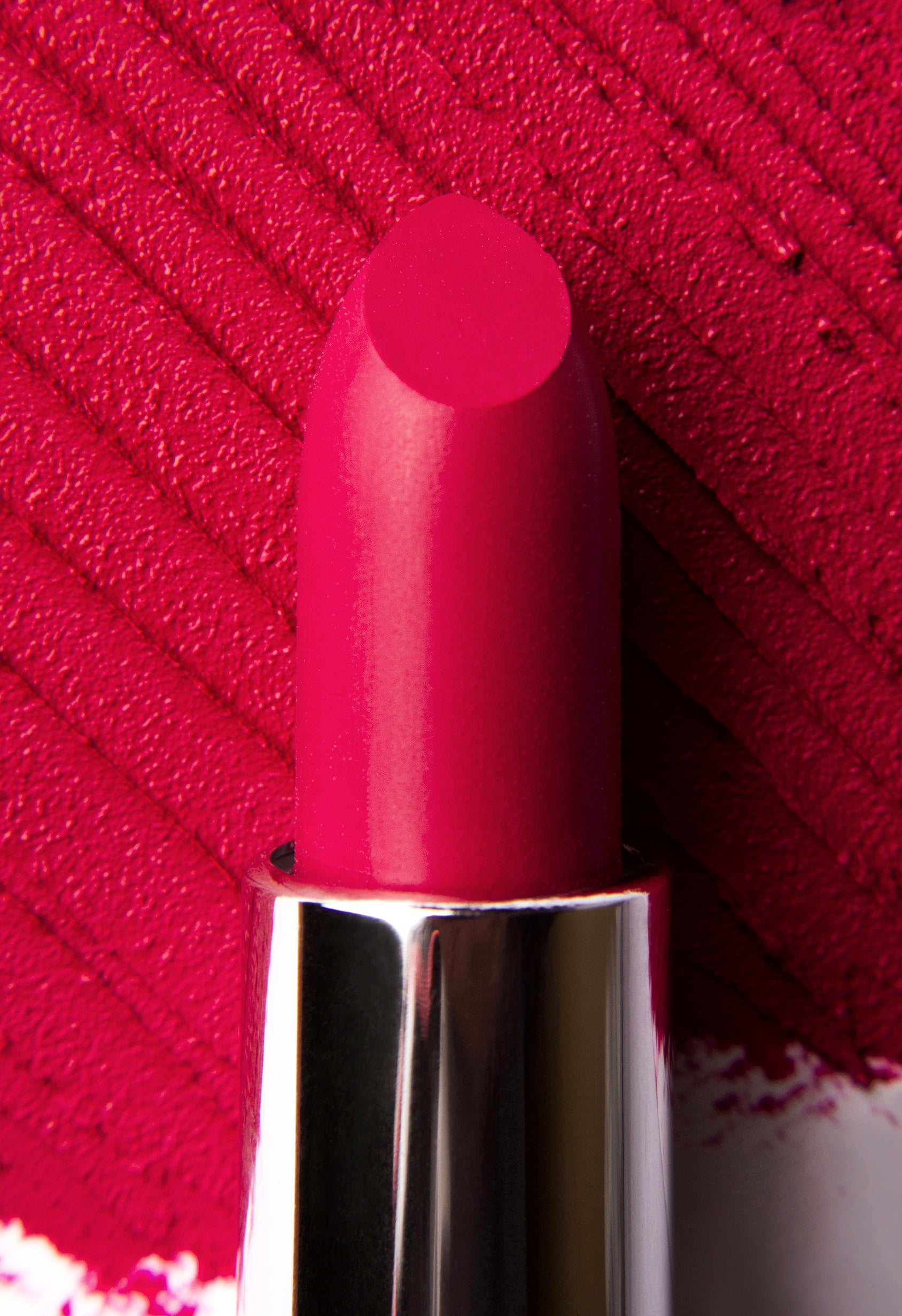 A vibrant pink marshmallow lipstick named Pink Horizons, showcasing its creamy texture and soft matte finish, perfect for adding a pop of color.