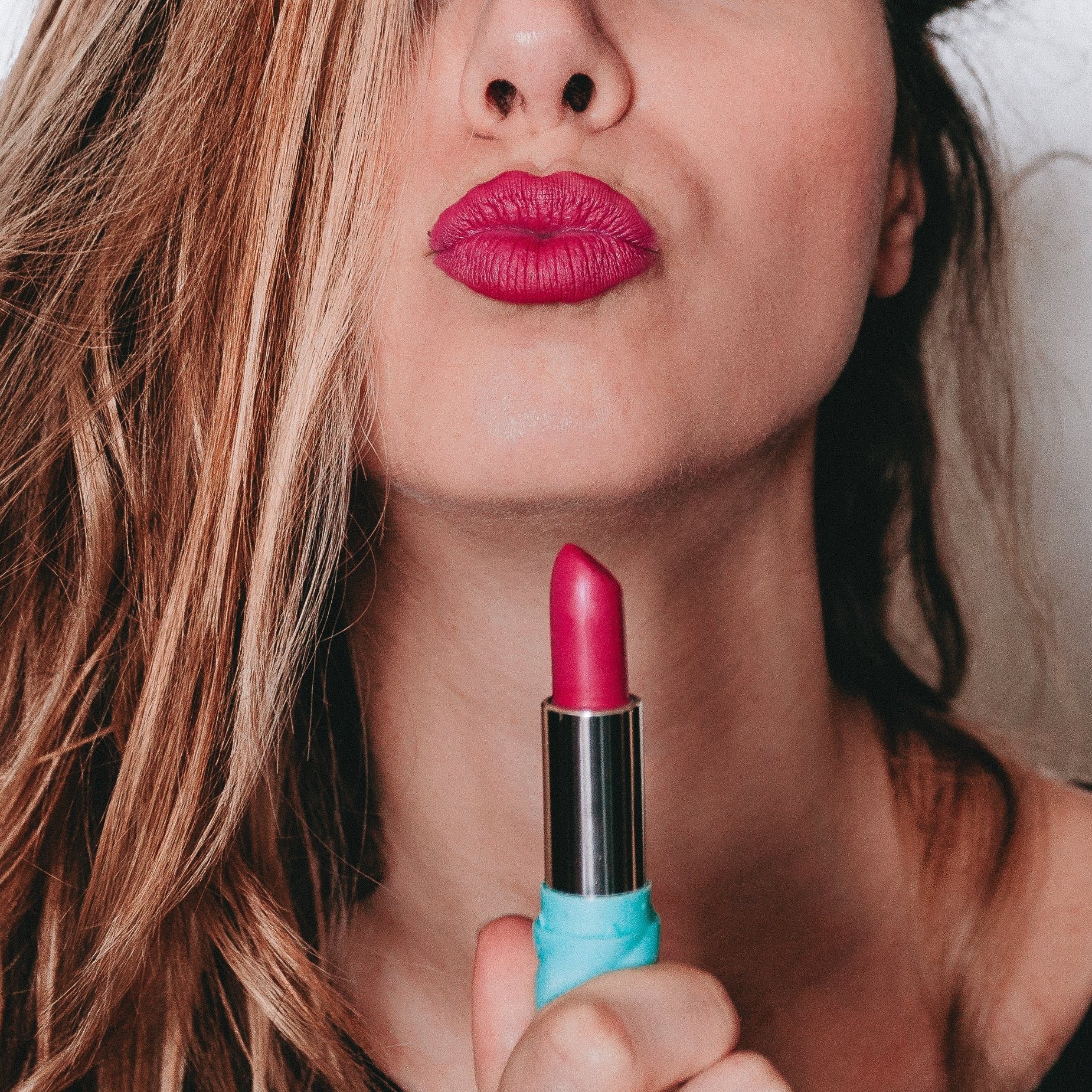 A vibrant pink marshmallow lipstick named Pink Horizons, showcasing its creamy texture and soft matte finish, perfect for adding a pop of color.