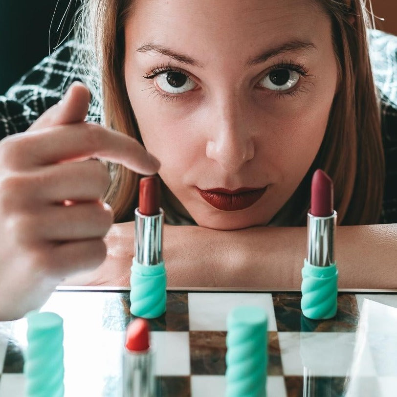 A close-up of 06 Rossetto 'Lady Maple from Colorland', showcasing its warm brick red color and creamy texture in a stylish packaging.