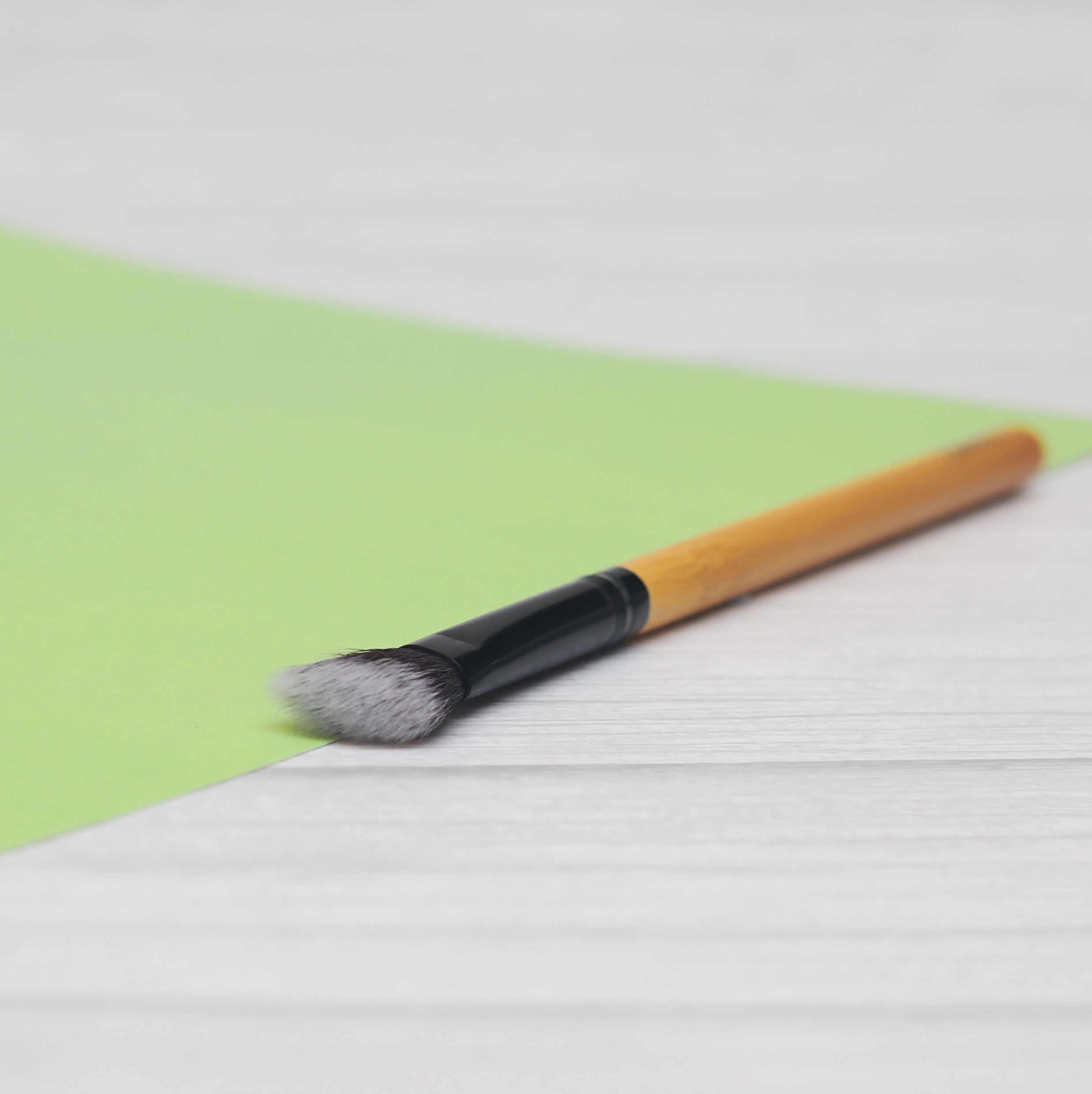 Angled Blending Bamboo Makeup Brush with soft synthetic bristles and durable bamboo handle, ideal for contouring and blending makeup.