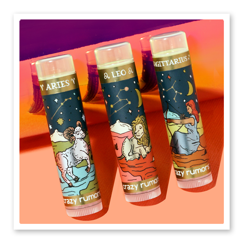 A vibrant product tube representing Aries, featuring fresh citrus and aromatic spice flavors, elegantly packaged in a gift box.