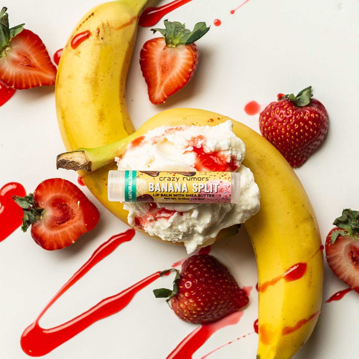 A vibrant Banana Split treat showcasing a blend of bananas, chocolate, and strawberries, topped with creamy vanilla, all in a 0.15oz tube.