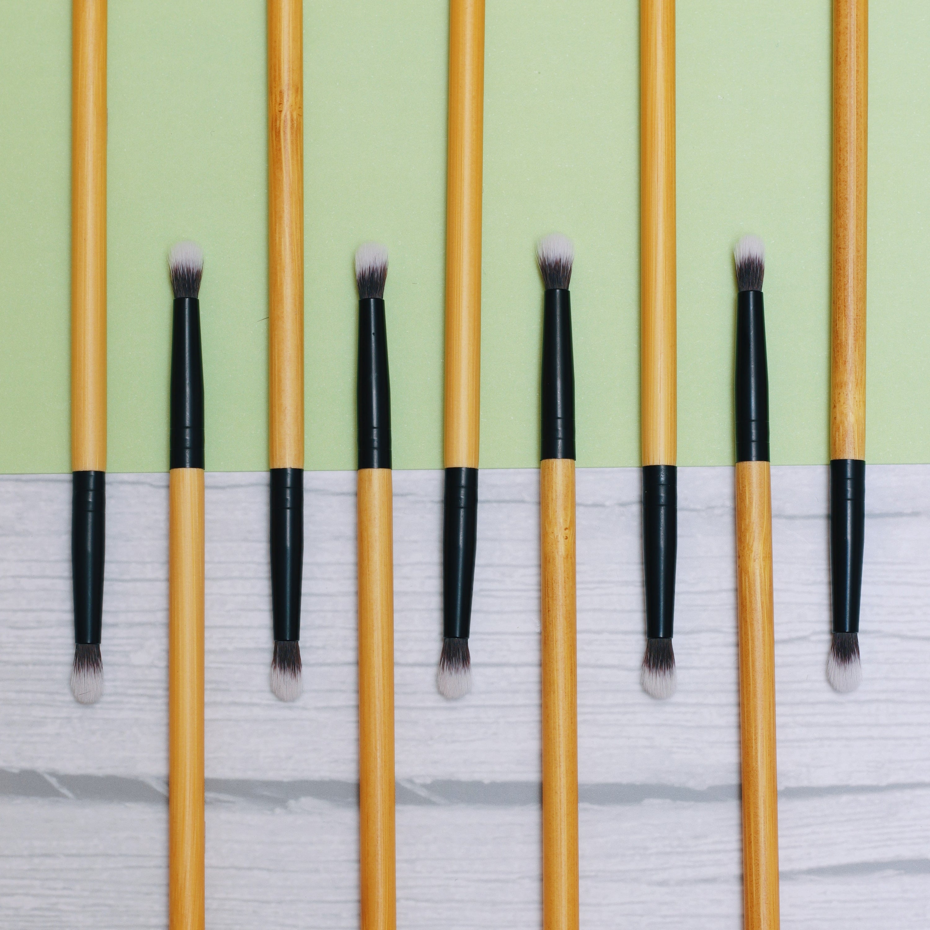 A close-up of a vegan detailing brush with a bamboo handle and soft synthetic bristles, ideal for precise makeup application.