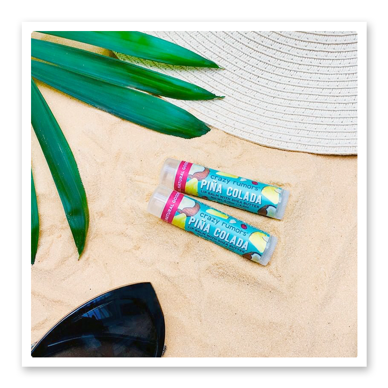 A vibrant Piña Colada product in a 0.15oz tube, featuring tropical pineapple and coconut imagery.