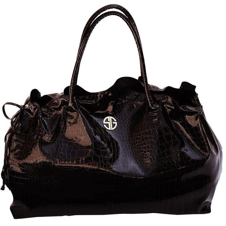 A stylish STUDIO GEAR COSMETICS Chocoholic Bag designed for cosmetics, featuring a luxurious chocolate color and spacious interior.