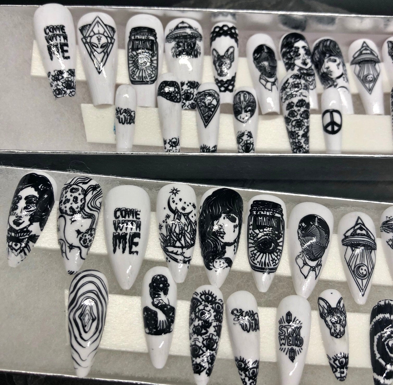 A set of 24 alien-themed false nails with various designs, perfect for press-on application and includes glue stickers.