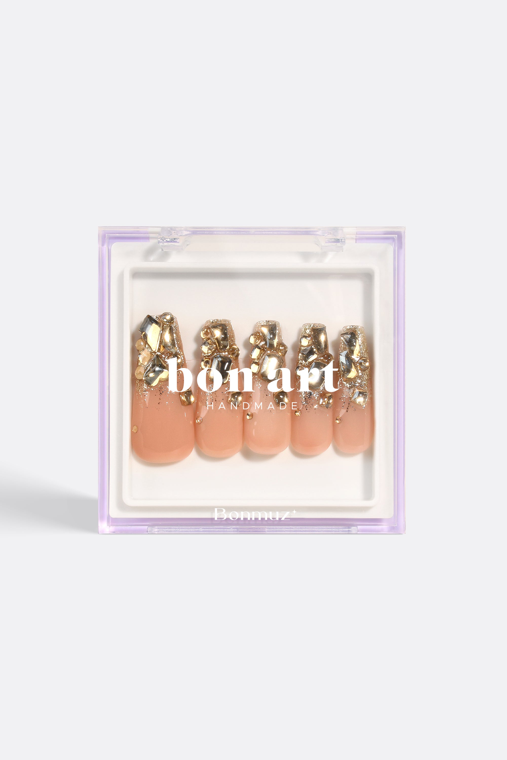 Gold embellished artificial nails set.