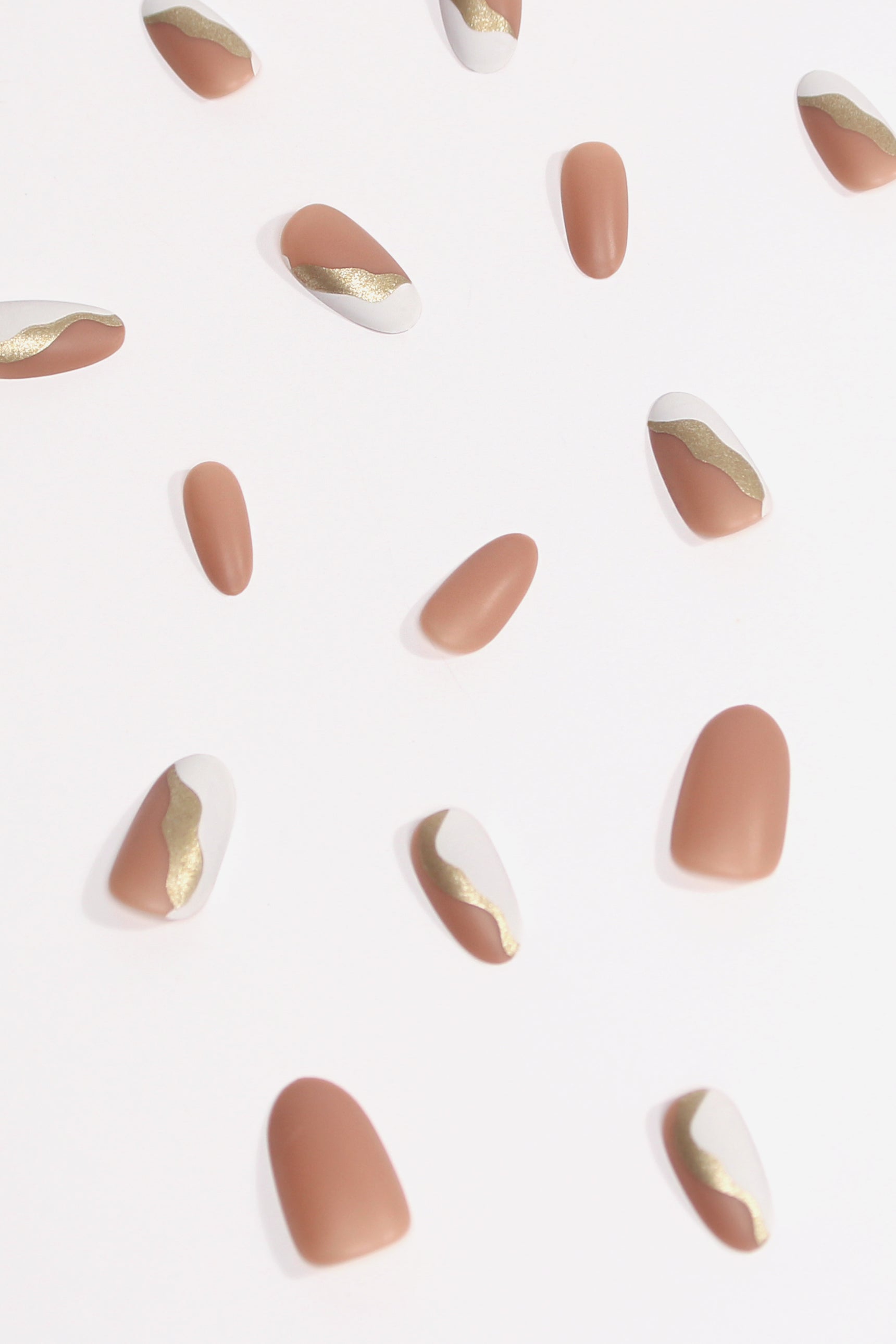 First Kiss press-on nails featuring gold glitter on a luxurious matte finish, elegantly displayed in a set.