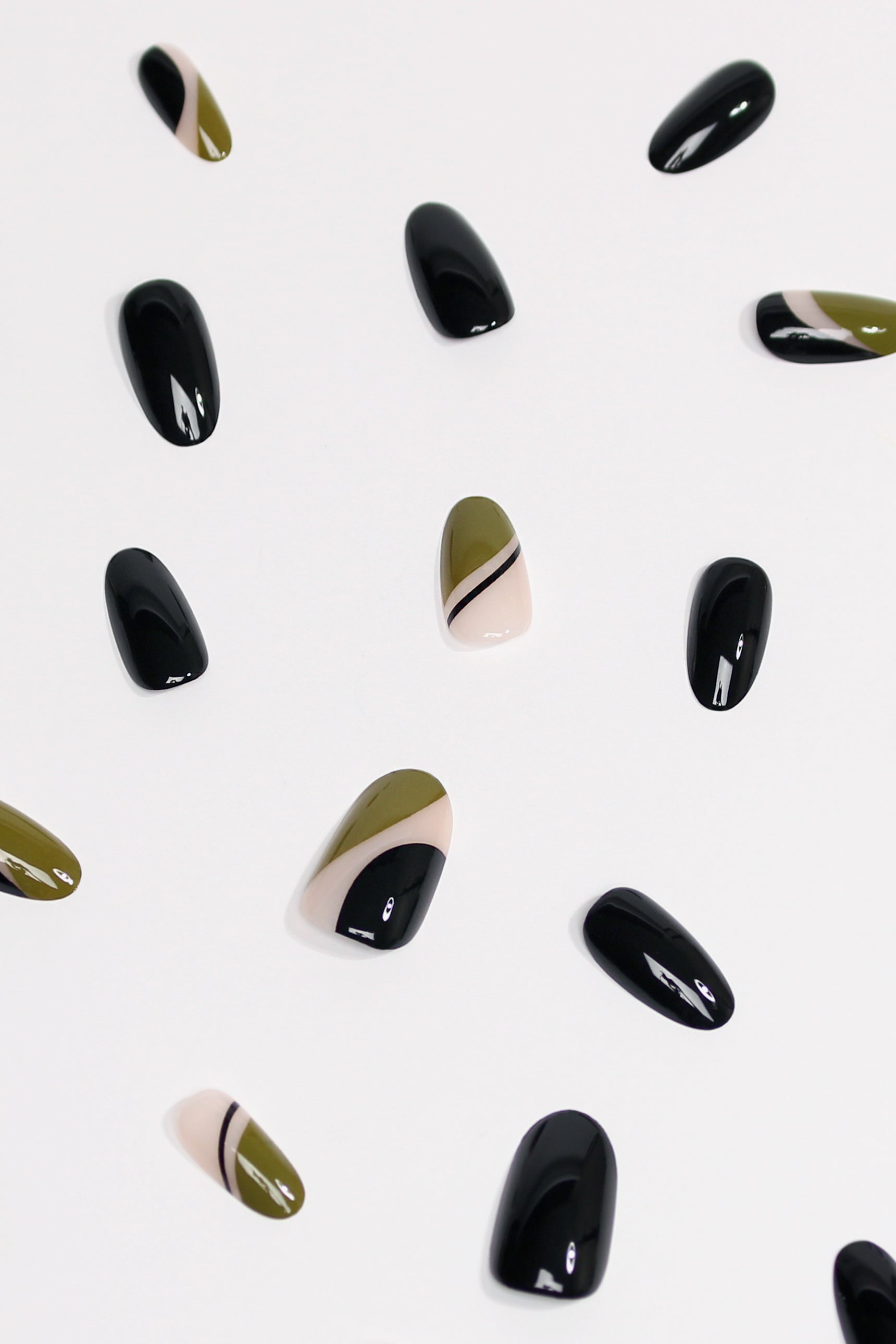 Mellow Olive press-on nails featuring a modern geometric design in olive and black, showcasing elegance and durability.