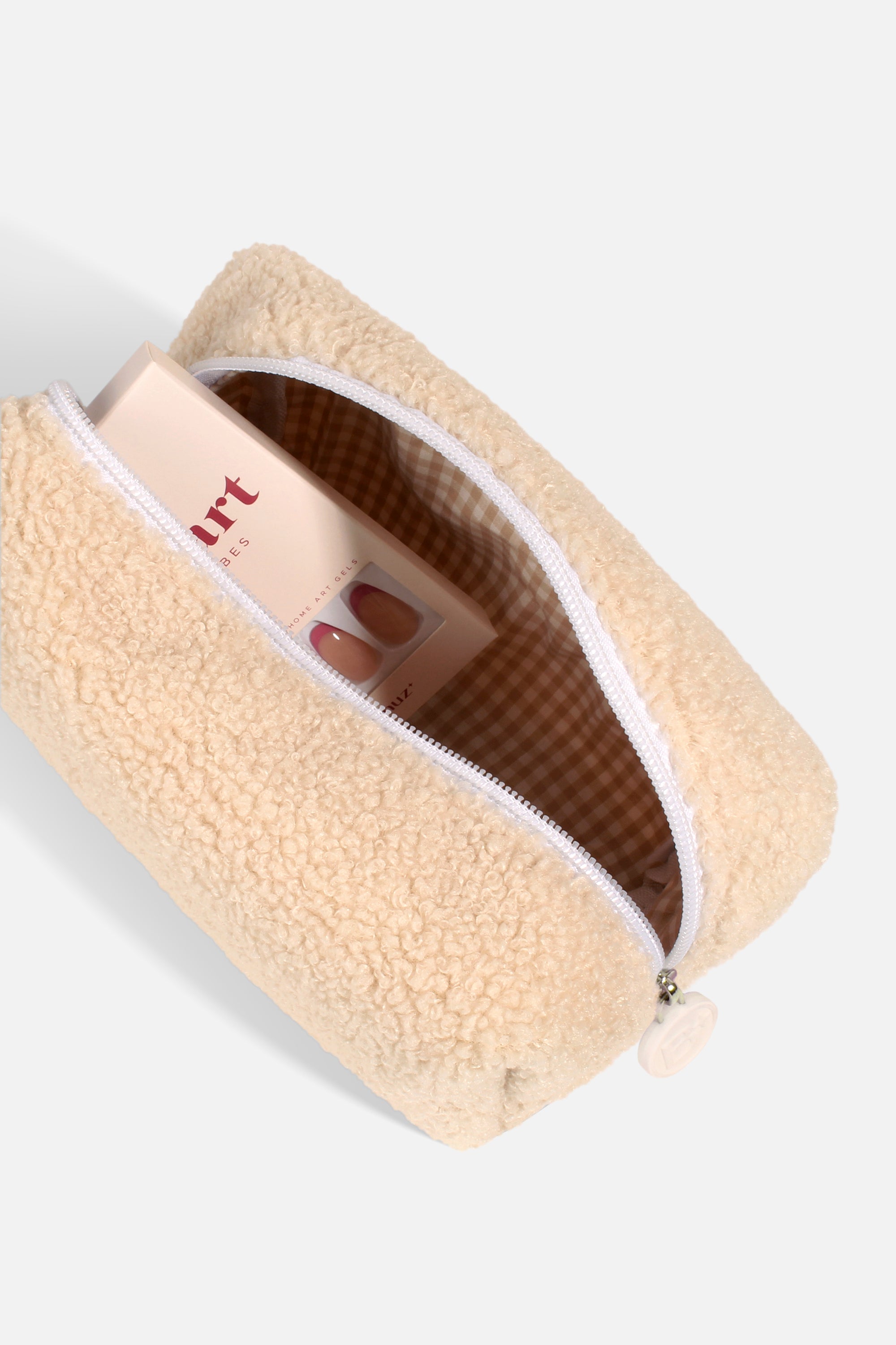 A soft and fluffy Polar Puff Pouch in cream and pastel purple, featuring a chic checkered interior design.