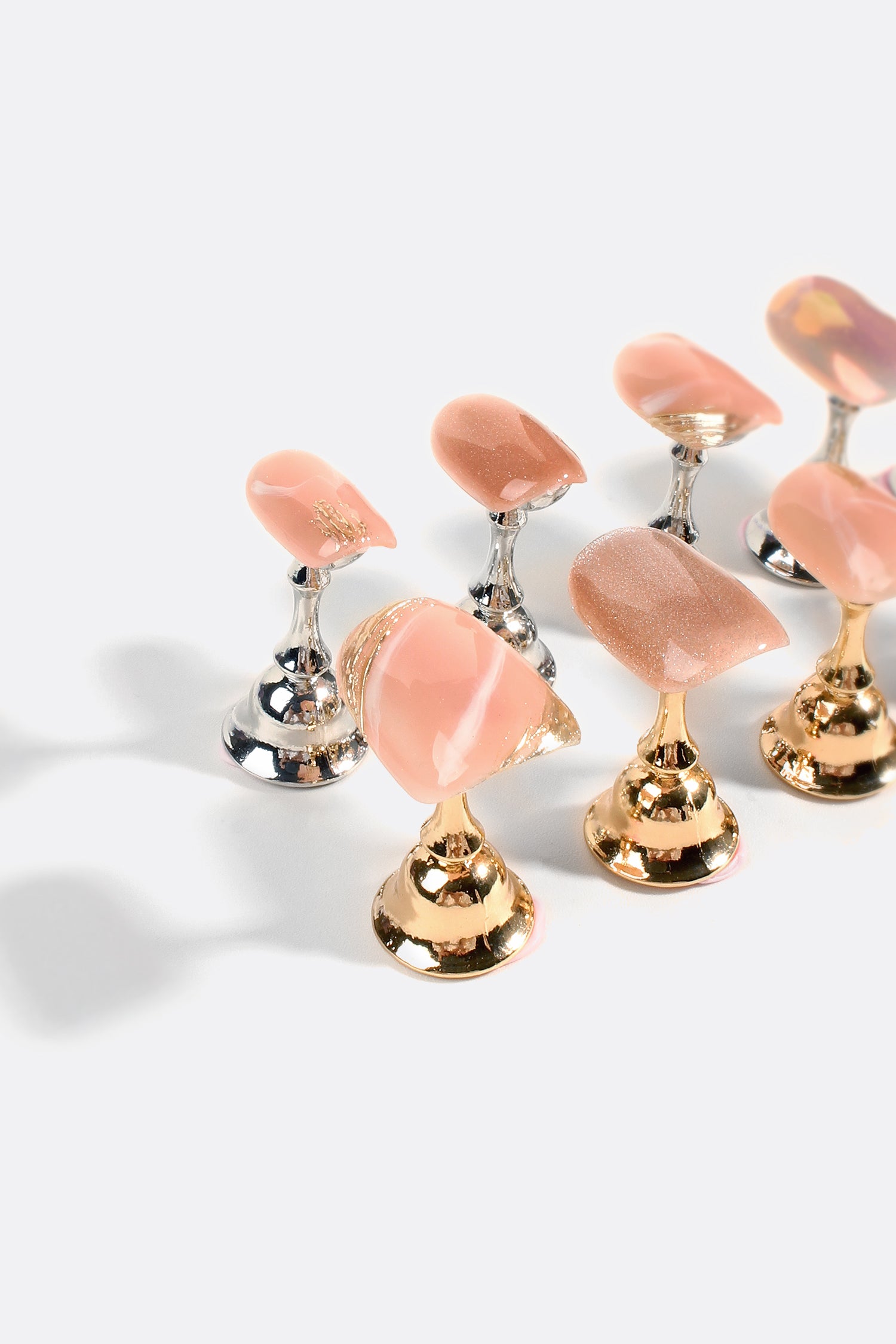 A set of Rose Gold Rush Pro Handmade Gel Nails featuring a shimmering rose gold finish with glittering and metallic accents.