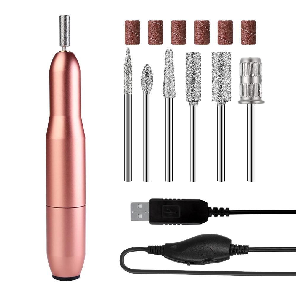 USB Nail Drill Set in rose gold color with six metal bits and USB power cord, ideal for portable nail care.