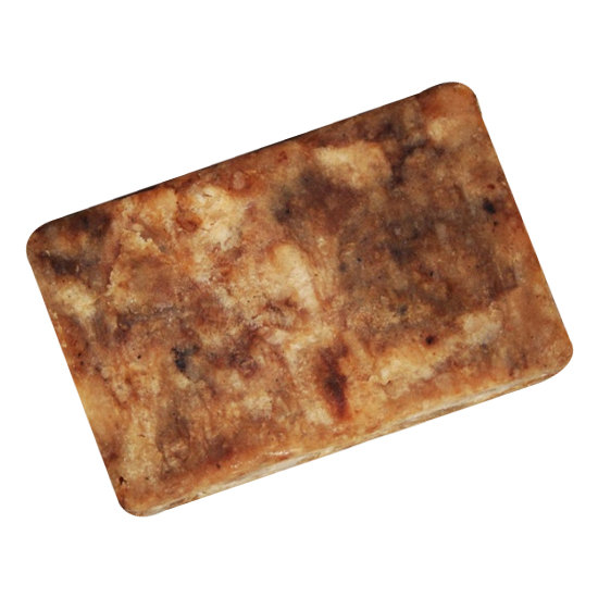 A bar of African Black Soap made from natural ingredients, showcasing its rich, dark color and rustic texture, symbolizing traditional West African craftsmanship.