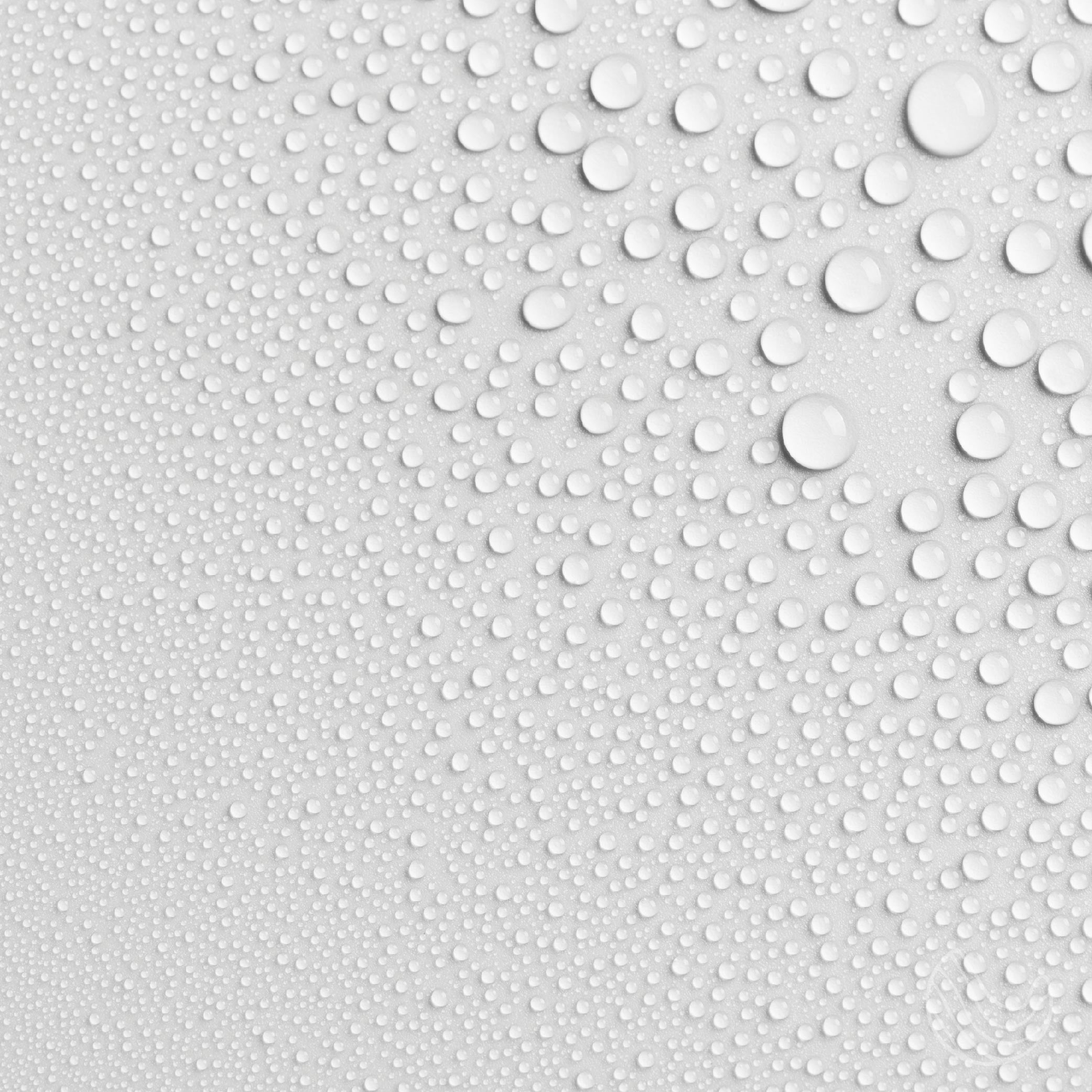 A bottle of All Natural Recharge Pillow & Linen Spray with a calming label, surrounded by soft linens and pillows, showcasing a serene bedtime atmosphere.