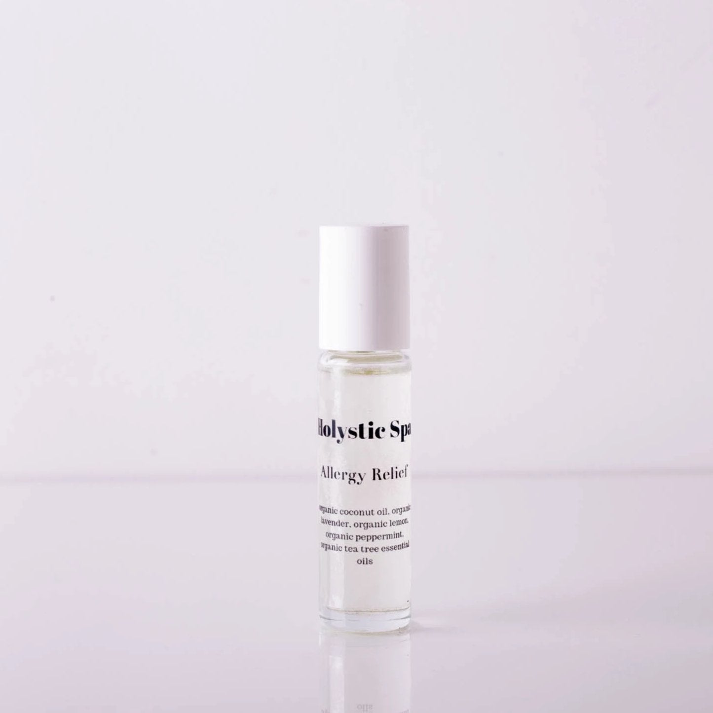 A bottle of Allergy Relief essential oil blend with a dropper, surrounded by fresh lavender and lemon slices, showcasing its natural ingredients.