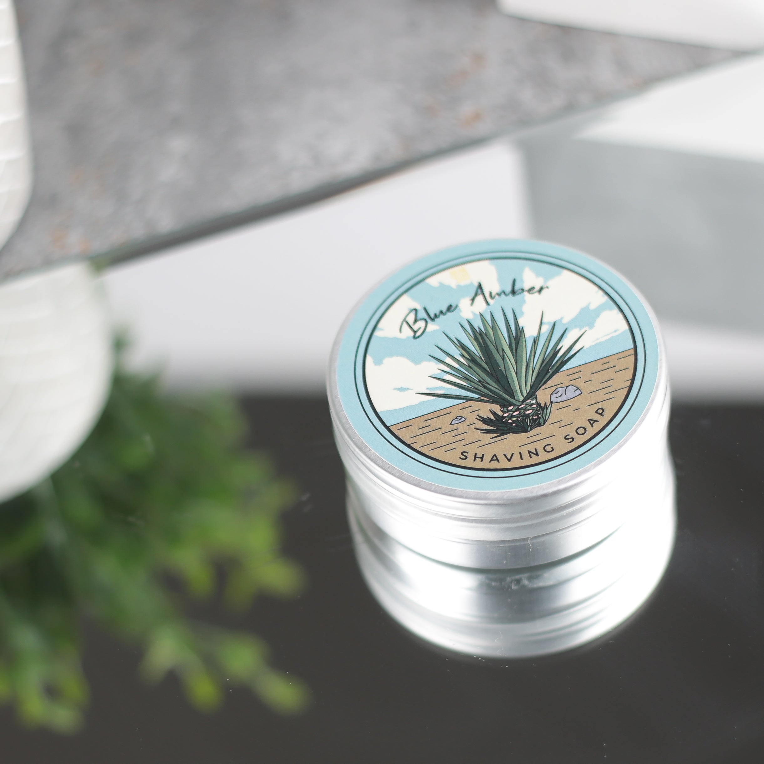 Blue Amber Shaving Soap in a round container, showcasing its rich texture and vibrant color, perfect for a luxurious shaving experience.