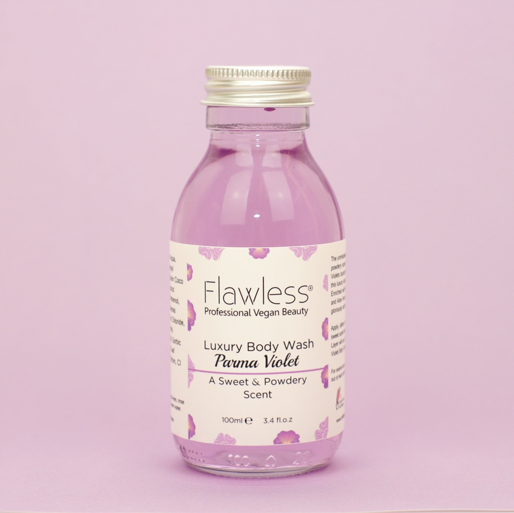 A luxurious Parma Violet body wash in a recycled glass bottle with an aluminum lid, showcasing its creamy texture and vibrant color.