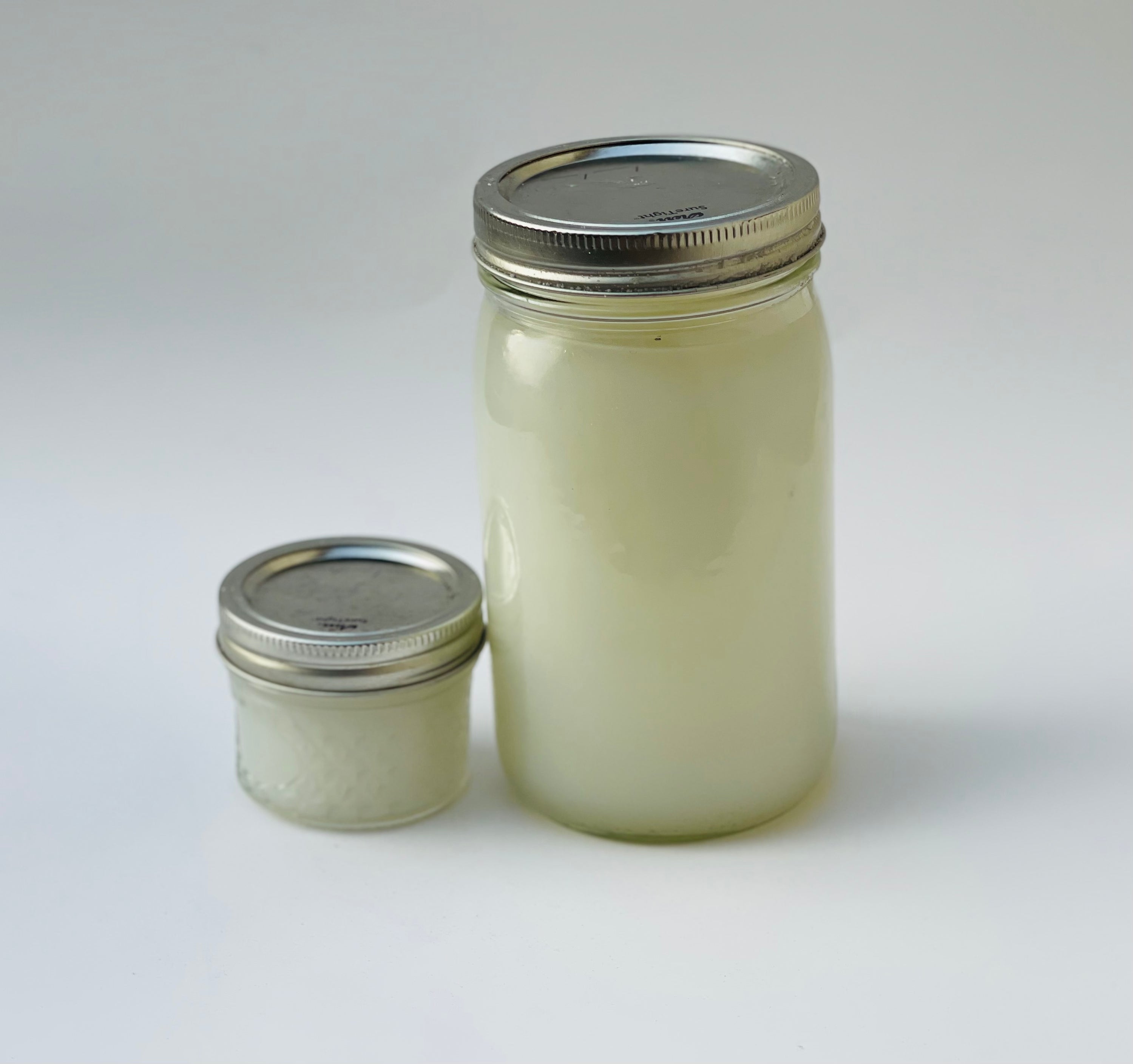 A bottle of eco-friendly Cleaning Spray Concentrate with a light tea tree and jasmine scent, ideal for various surfaces.